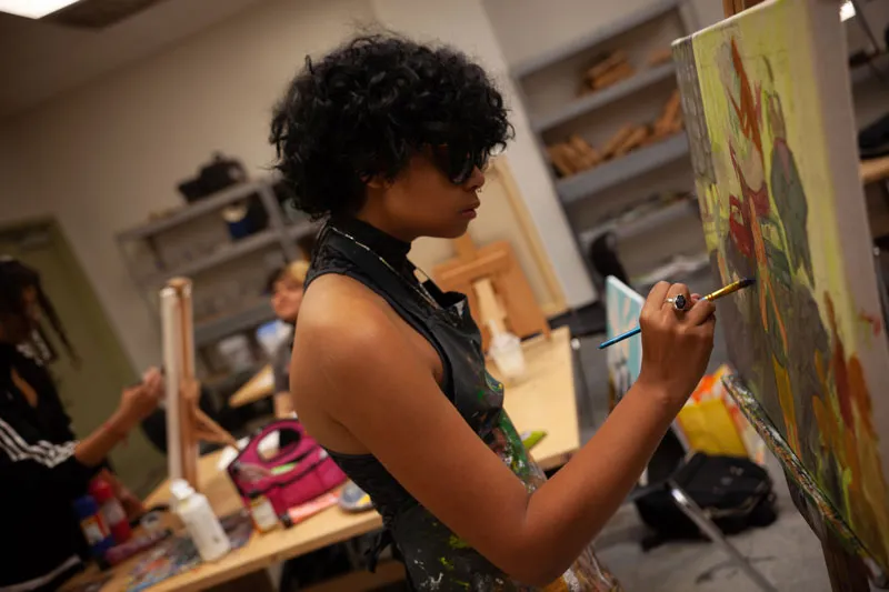Visual Art student painting in class