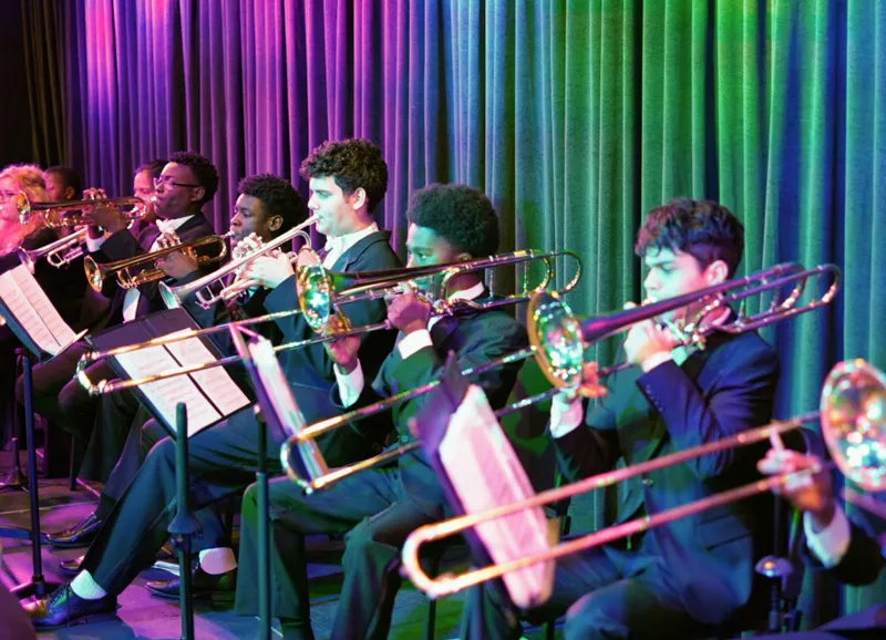 Students performing with instruments 