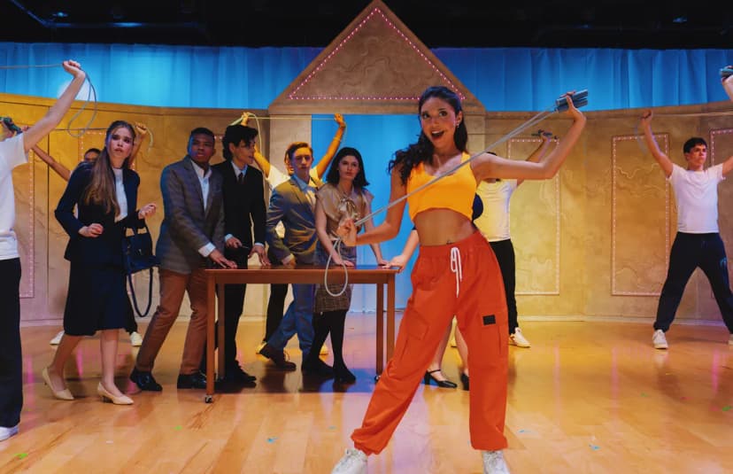 Musical Theatre students in the main focus with more students in the back, students performing on the stage 